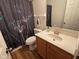 Bathroom featuring floral shower curtain, wood vanity and laminate flooring at 7970 Cobblesprings Dr, Avon, IN 46123