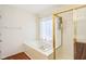 Bathroom featuring a soaking tub with a shower head and gold-colored trim on the glass door at 7970 Cobblesprings Dr, Avon, IN 46123