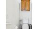 Full bathroom featuring a toilet with wooden cabinets above it and neutral paint at 7970 Cobblesprings Dr, Avon, IN 46123