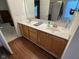 Bathroom with dual sinks, oak vanity, and a glass enclosed tub and shower combo at 7970 Cobblesprings Dr, Avon, IN 46123