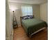 Bedroom with wood floors, a lamp and a window for natural light at 7970 Cobblesprings Dr, Avon, IN 46123