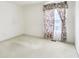 Empty bedroom with neutral carpet, floral curtains, and natural light from the window at 7970 Cobblesprings Dr, Avon, IN 46123
