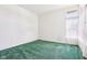 Neutral bedroom with a large window providing natural light and green carpeting at 7970 Cobblesprings Dr, Avon, IN 46123