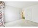 A bright bedroom has neutral carpet and walls, with a glimpse of an ensuite bathroom through an open door at 7970 Cobblesprings Dr, Avon, IN 46123