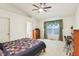 A light-filled bedroom with a ceiling fan, window, and furnishings at 7970 Cobblesprings Dr, Avon, IN 46123