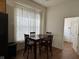 Breakfast nook with wood table and chairs, and natural light from the adjacent windows at 7970 Cobblesprings Dr, Avon, IN 46123