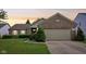Charming single-story brick home with well-manicured lawn and attached two-car garage at 7970 Cobblesprings Dr, Avon, IN 46123