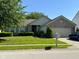 Charming single-story home with brick accents, lush landscaping, and a well-maintained lawn at 7970 Cobblesprings Dr, Avon, IN 46123