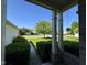 Inviting covered front porch with brick accents and view of well-maintained lawn and tree at 7970 Cobblesprings Dr, Avon, IN 46123