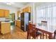Bright kitchen features wood floors, dining table, and modern appliances at 7970 Cobblesprings Dr, Avon, IN 46123