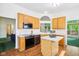 Well-lit kitchen with a center island, black appliances, and wood cabinets, designed for functionality at 7970 Cobblesprings Dr, Avon, IN 46123