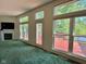 Bright living room featuring a fireplace and large windows overlooking the expansive deck at 7970 Cobblesprings Dr, Avon, IN 46123