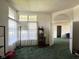 Bright living room featuring large windows, an arched doorway, and green carpeting at 7970 Cobblesprings Dr, Avon, IN 46123