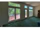 Spacious living room with multiple windows offering views of the outdoor deck and landscape at 7970 Cobblesprings Dr, Avon, IN 46123