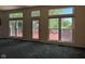 Living room with multiple windows leading out to a private deck at 7970 Cobblesprings Dr, Avon, IN 46123