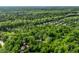 Lush aerial view of secluded homes nestled among mature trees, providing privacy and a natural setting at 8209 Beech Knoll, Indianapolis, IN 46256