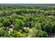 Aerial view of a home nestled among lush green trees, showcasing its serene and private setting within a wooded area at 8209 Beech Knoll, Indianapolis, IN 46256