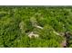 Expansive aerial view showcasing a secluded property surrounded by a dense forest, ensuring tranquility at 8209 Beech Knoll, Indianapolis, IN 46256
