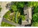 Aerial view of home showing driveway, manicured garden, and mature trees providing ample shade and seclusion at 8209 Beech Knoll, Indianapolis, IN 46256