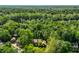 Aerial view of a home surrounded by a dense forest, highlighting its secluded location and natural beauty at 8209 Beech Knoll, Indianapolis, IN 46256