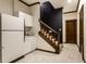Basement kitchenette and stairs with updated flooring and wood trim, great for guests at 8209 Beech Knoll, Indianapolis, IN 46256