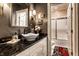 Powder room featuring dark walls, elegant sink, and unique fixtures at 8209 Beech Knoll, Indianapolis, IN 46256