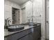 Modern bathroom featuring dual vessel sinks with a granite countertop and patterned wallpaper at 8209 Beech Knoll, Indianapolis, IN 46256
