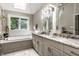 Bright bathroom with a large vanity, granite counters, and a soaking tub under a skylight at 8209 Beech Knoll, Indianapolis, IN 46256