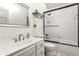 Bathroom with white tiled shower over tub and a vanity with decorative hardware at 8209 Beech Knoll, Indianapolis, IN 46256