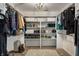 Spacious walk-in closet with built-in shelving, a decorative chandelier, and carpeted flooring at 8209 Beech Knoll, Indianapolis, IN 46256