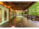 Spacious deck with wooden bench seating overlooks the lush backyard greenery, creating a serene outdoor living space at 8209 Beech Knoll, Indianapolis, IN 46256
