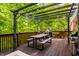 Inviting outdoor deck with pergola, dining table, grill, and lush green surroundings, perfect for relaxation and entertaining at 8209 Beech Knoll, Indianapolis, IN 46256