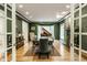 Dining room features hardwood floors, a piano, a fireplace, and an area rug at 8209 Beech Knoll, Indianapolis, IN 46256
