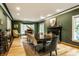 Dining room features a fireplace, hardwood floors, an area rug, and a piano in an adjacent area at 8209 Beech Knoll, Indianapolis, IN 46256