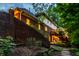 Exterior view of the home features a brick facade, a multi-tiered deck, and a well-manicured garden area at 8209 Beech Knoll, Indianapolis, IN 46256