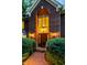 Stylish brick entryway with large windows, wooden front door, and manicured shrubs at 8209 Beech Knoll, Indianapolis, IN 46256