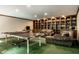 Spacious game room boasts custom built-ins, comfortable seating, and a ping pong table for endless entertainment possibilities at 8209 Beech Knoll, Indianapolis, IN 46256