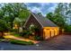 Attached three-car garage and brick trim with garden and walkway to the main house at 8209 Beech Knoll, Indianapolis, IN 46256