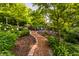 Beautiful garden path with lush greenery, brick accents, and comfortable seating for relaxing outdoors at 8209 Beech Knoll, Indianapolis, IN 46256