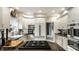 Bright kitchen featuring white cabinets, a gray island, and stainless steel appliances at 8209 Beech Knoll, Indianapolis, IN 46256