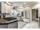 Bright kitchen featuring white cabinets, a gray island, and stainless steel appliances at 8209 Beech Knoll, Indianapolis, IN 46256
