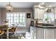 Bright kitchen featuring white cabinets and a gray island with seating plus a garden view at 8209 Beech Knoll, Indianapolis, IN 46256