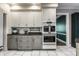 Bright kitchen featuring white cabinets, double ovens and a tiled floor at 8209 Beech Knoll, Indianapolis, IN 46256