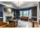 Comfortable living room with hardwood floors, a decorative fireplace, and a bay window at 8209 Beech Knoll, Indianapolis, IN 46256