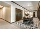 Charming dining area with wood table and chairs, complemented by a stylish rug and a glimpse into the adjacent living room at 8209 Beech Knoll, Indianapolis, IN 46256