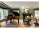 Spacious living room featuring a grand piano, fireplace, and dining table with chairs at 8209 Beech Knoll, Indianapolis, IN 46256