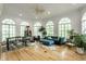 Bright living room features hardwood floors, a ceiling fan, a sofa, and large arched windows for natural light at 8209 Beech Knoll, Indianapolis, IN 46256