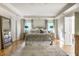 Spacious primary bedroom with hardwood floors, tray ceilings, and abundant natural light at 8209 Beech Knoll, Indianapolis, IN 46256
