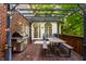 Outdoor patio with dining set, grill, and double doors leading to the home's interior for easy entertaining at 8209 Beech Knoll, Indianapolis, IN 46256