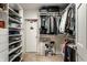 Organized walk-in closet featuring shelves, hanging rods, and a door to extra storage at 8209 Beech Knoll, Indianapolis, IN 46256
